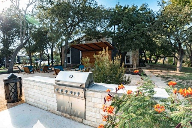 Outdoor kitchen with a built-in grill and stone counter