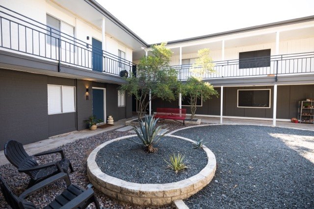 Courtyard with a gravel bed and stone-ringed planter