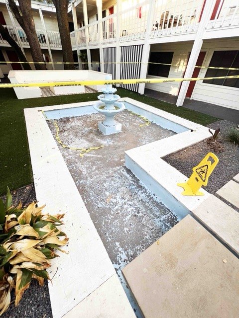 Fountain basin being rebuilt with new stone coping